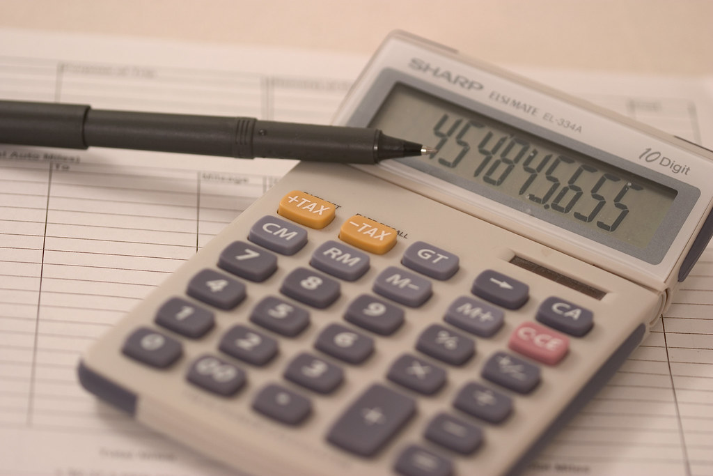 Calculator, pen and ledger used to prepare an NGO tax exemption application in Kenya