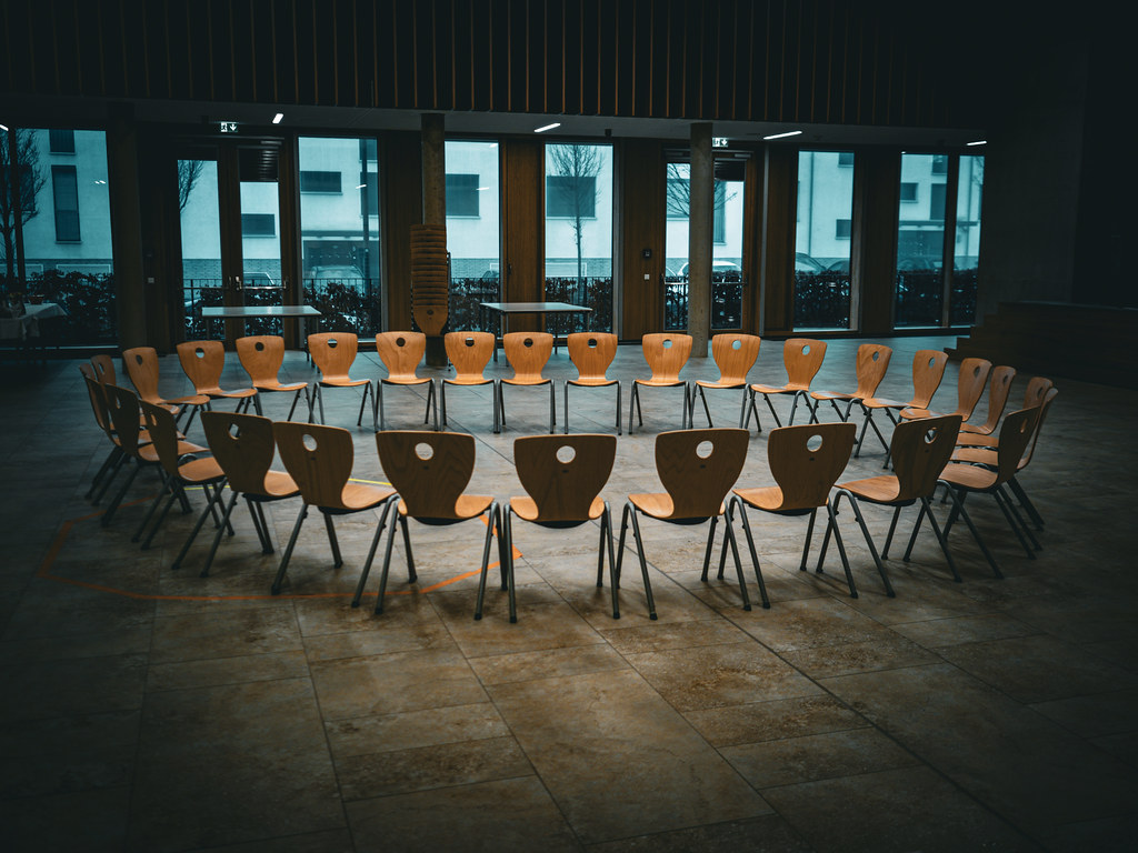 Empty chairs arranged in a circle for a World Mental Health Day peer support session