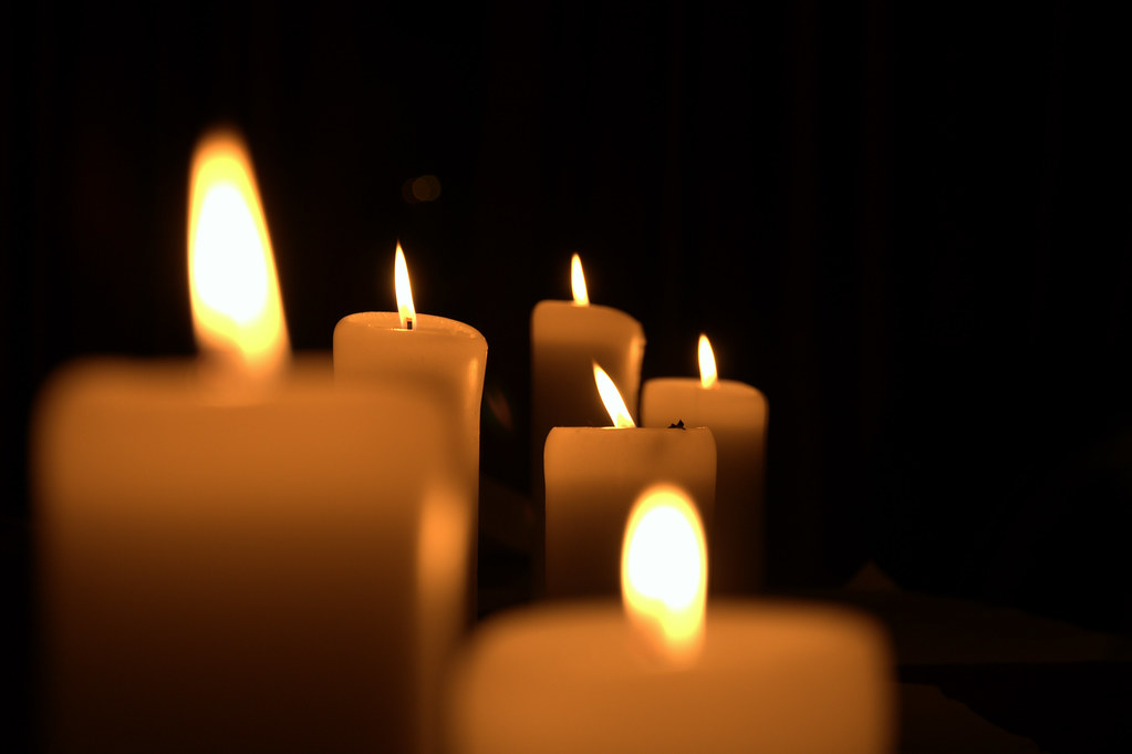Row of lit candles at a vigil marking World Suicide Prevention Day mental health awareness