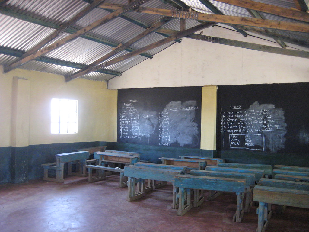 Empty Kenyan classroom with wooden desks and chalkboards, a setting for World Children's Day 2026 child protection work