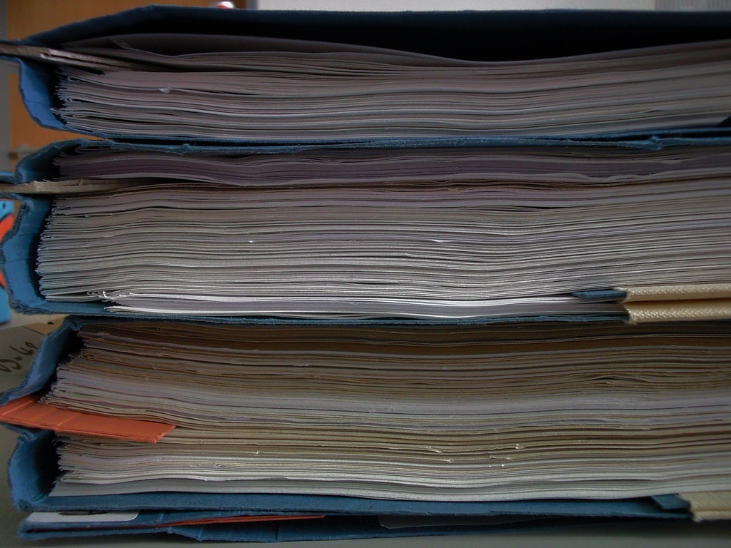 Stacked binders of paperwork, ready for PBO annual returns filing in Kenya