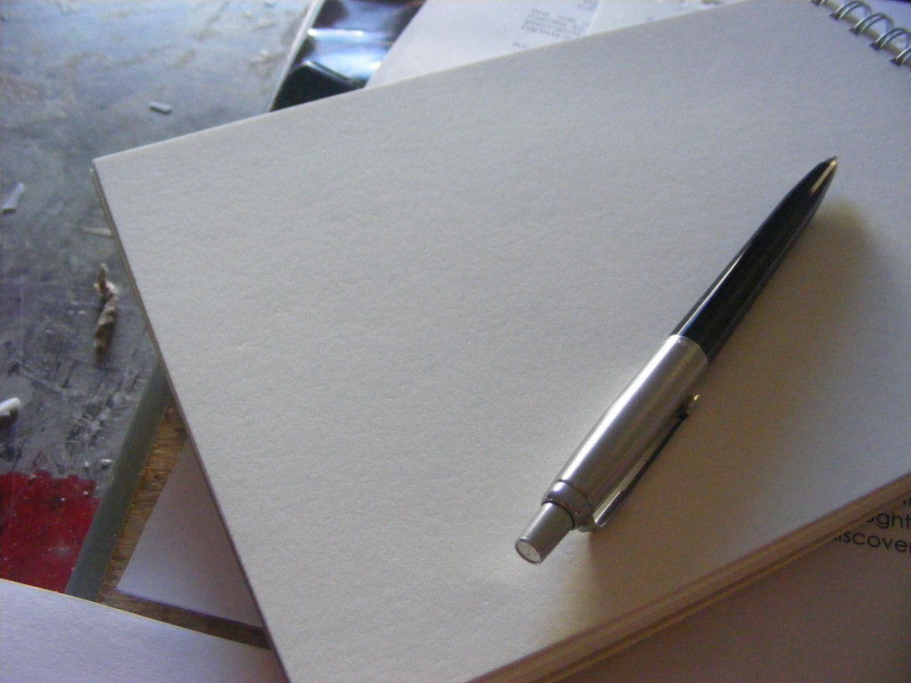 Pen resting on a blank notebook, ready for a rolling grants application by a Kenyan NGO